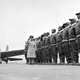 Maj James A. Ellison reviews first class of Tuskegee Airmen in 1941. A Vultee BT-13 Valiant trainer, better known as the Vultee Vibrator, is parked at the left. (US Air Force)